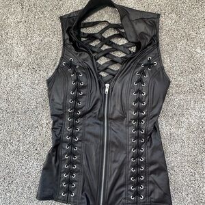 LYDIA USA black zip up top with strappy back and lace up detail on front.